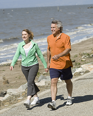 Mujer y hombre caminando por la playa.